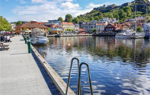 a harbor with boats in the water and a town at 2 Bedroom Cozy Home In Halden in Halden