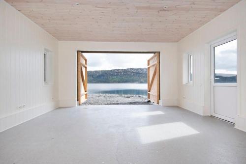 an empty room with a view of a body of water at Helt ny rorbu på Slyngstad i Ålesund Kommune in Ålesund