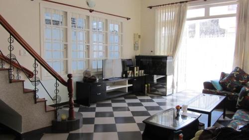 a living room with a checkered floor at City Pass Da Lat in Da Lat