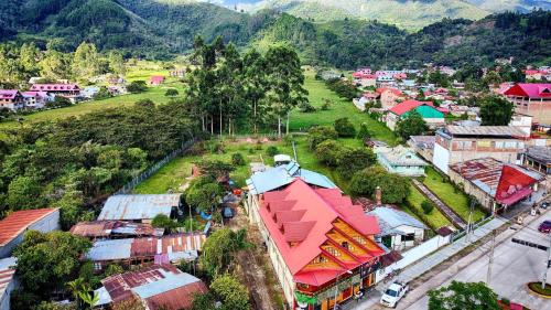 an aerial view of a small town in a mountain at Hospedajes & Cabañas Tunki Lodge in Oxapampa
