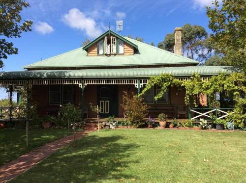 a house with a green roof and a yard at Butterfly Farm Bed and Breakfast Nirranda in Nirranda