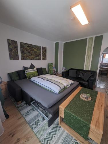 a bedroom with a bed and a living room at Ferienwohnung Walter Gluche in Pittenhart