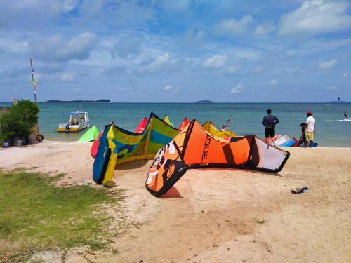 a group of kites sitting on the beach at Ten RooMs in Telukbakau
