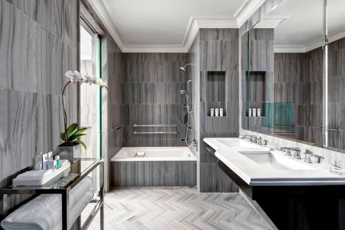a bathroom with a tub and a sink at The St. Regis New York in New York