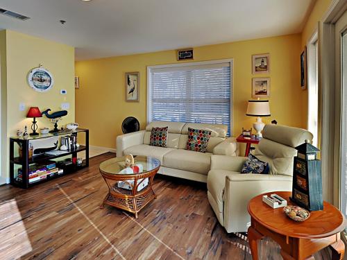 a living room with a couch and a table at Grand Caribbean Perdido Key #101 West in Perdido Key