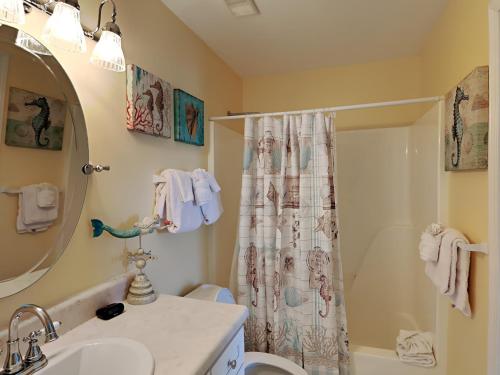 a bathroom with a shower curtain and a sink at Grand Caribbean Perdido Key #101 West in Perdido Key