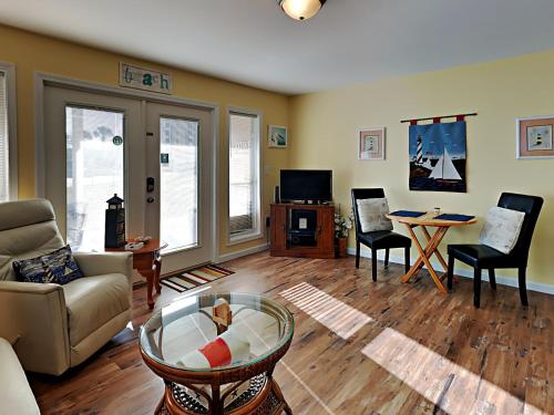 a living room with a couch and a table at Grand Caribbean Perdido Key #101 West in Perdido Key