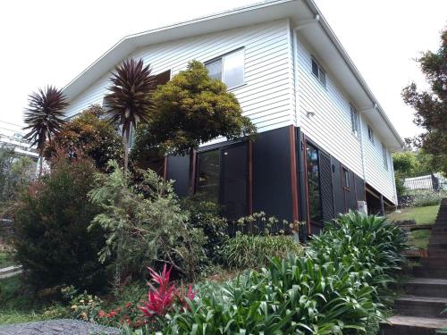 a house with black doors and plants at La maison noire in Maleny