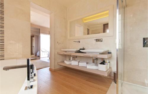 a bathroom with a sink and a mirror at Lovely Home In Vabriga With Kitchen in Vabriga