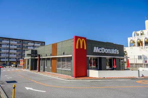 a mcdonalds store on the side of a street at 最大12人築浅物件 南部を満喫したい方に1番のおすすめ宿 無料駐車場3台 サウスウィンドハウス in Inamine