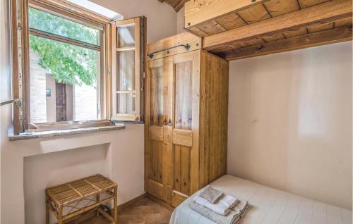 a bedroom with a wooden cabinet and a window at Casa Panorama in Ostra Vetere