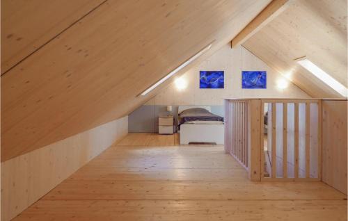 a attic room with a bed and a wooden floor at Ferienhaus 4 Wolfschlucht in Prüm