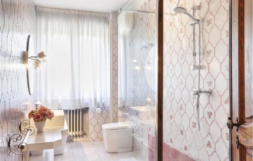 a bathroom with a shower and a toilet and a sink at Villa Oleandro in Fauglia