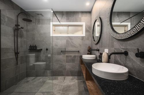 a bathroom with a sink and a mirror at The Grove Estate in Porepunkah