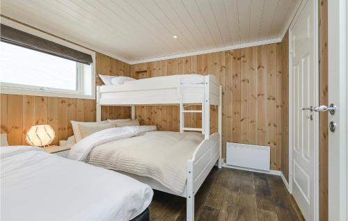 two bunk beds in a room with wooden walls at Sjusjen Setergrend 4724 C in Sjusjøen