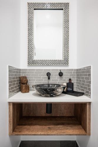 a bathroom with a sink and a mirror at The Grove Estate in Porepunkah