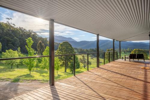 a balcony with a view of the mountains at The Grove Estate in Porepunkah