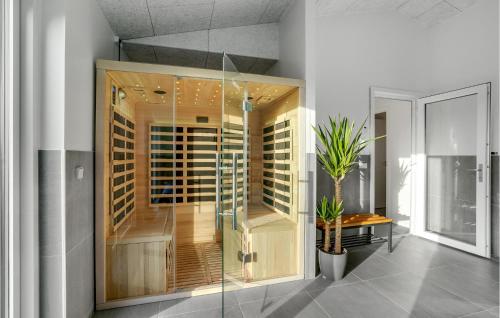 a glass shower in a room with a wine cellar at Nice Home In Hadsund With Sauna in Hadsund