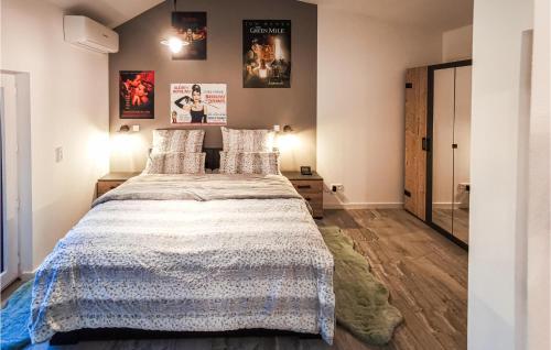 a bedroom with a large bed and a mirror at 2 Bedroom Beautiful Home In Ulrichstein in Ulrichstein