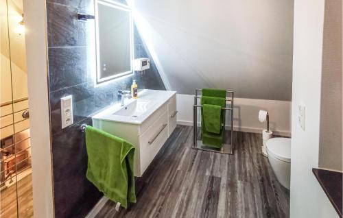 a bathroom with a white sink and a toilet at 2 Bedroom Beautiful Home In Ulrichstein in Ulrichstein