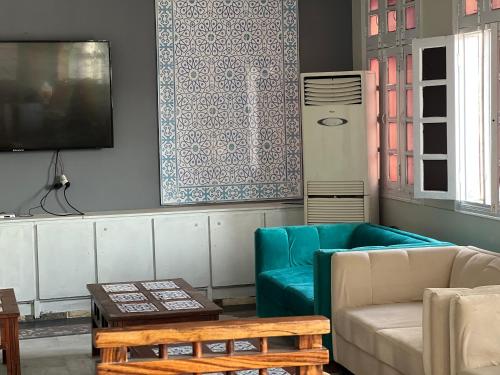 a living room with a couch and a table at Hotel Hayatt Sukkur in Kalar Goth