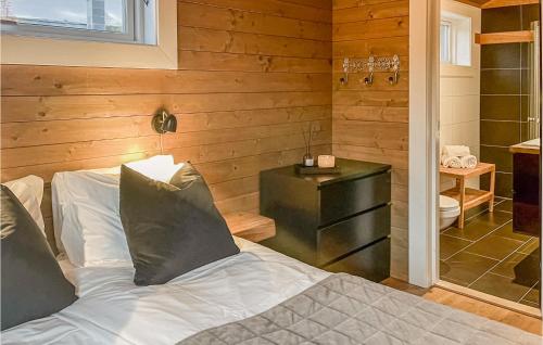 a bedroom with a white bed and a bathroom at 5 Bedroom Cozy Home In Hemsedal in Hemsedal
