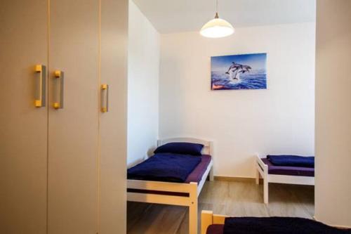 a small room with a bed and a closet at Nemira Sunny Apartments in Omiš