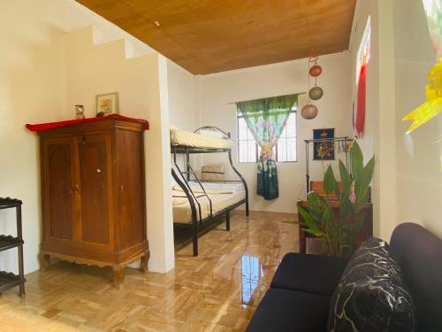 a living room with a couch and a bunk bed at Eastdee Homestay By Jaya in Lidlidda