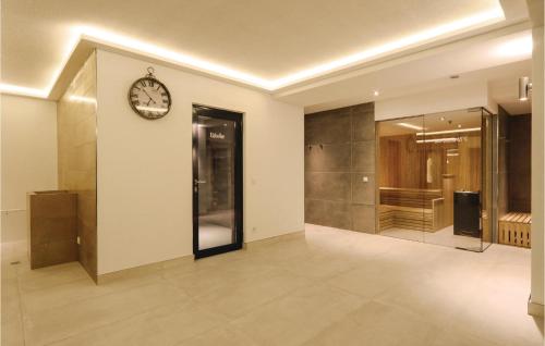 a room with a clock on the wall and a hallway at Amber in Binz