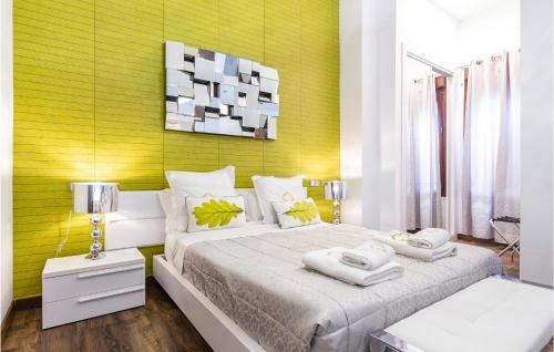 a bedroom with a large bed and a yellow wall at Stunning Apartment In Sevilla With Wifi in Seville