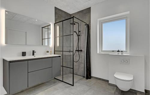a bathroom with a shower and a toilet and a sink at 6 Bedroom Cozy Home In Ebeltoft in Ebeltoft