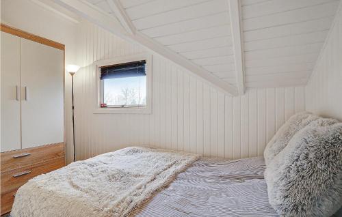 a white bedroom with a bed and a window at 2 Bedroom Stunning Home In Karrebksminde in Karrebæksminde
