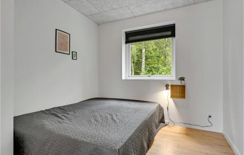 a bedroom with a bed and a window at 6 Bedroom Cozy Home In Ebeltoft in Ebeltoft
