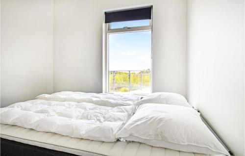 a white bed in a room with a window at Beautiful Home In Spttrup With Sauna in Spottrup