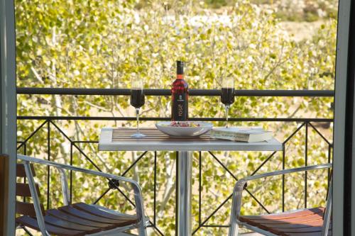 a bottle of wine sitting on a table on a balcony at Iris Apartments in Minia