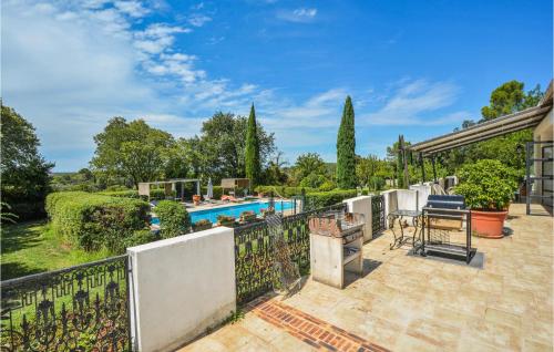 an outdoor patio with a fence and a swimming pool at Grand Pavillion in Aubais