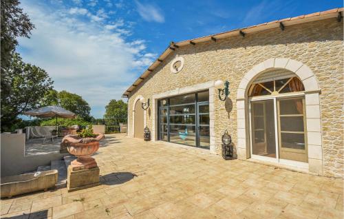 a patio in front of a brick building at Grand Pavillion in Aubais