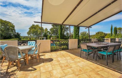 an outdoor patio with a table and chairs at Grand Pavillion in Aubais