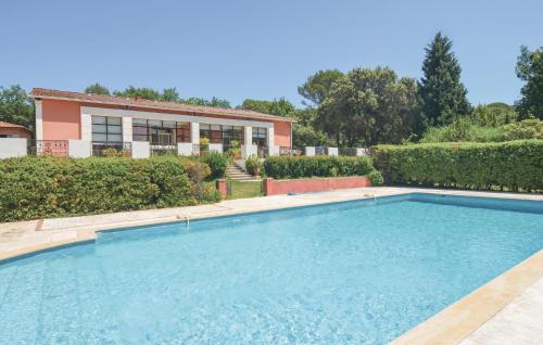 a swimming pool in front of a house at Grand Pavillion in Aubais