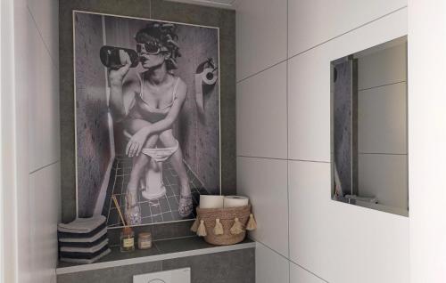 a bathroom with a picture of a woman on the wall at Statendam 12 Oh Laak in Ohé en Laak