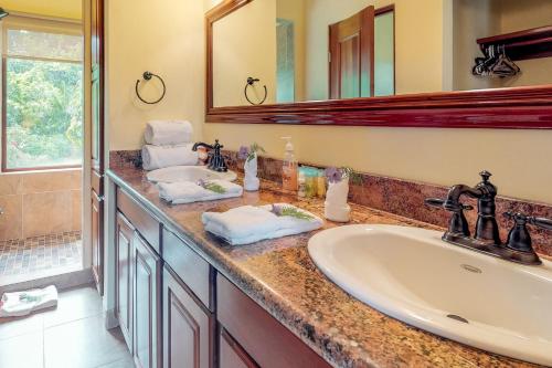 a bathroom with a sink and a mirror at Casita at Morningstar Breeze Gold Standard Certified in Hopkins