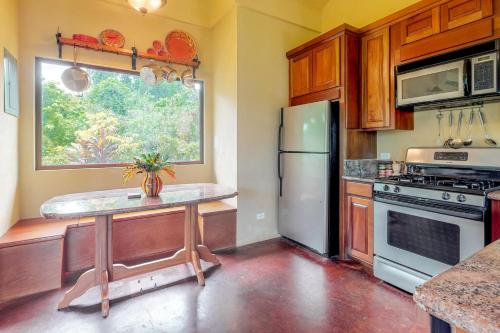 a kitchen with a refrigerator and a table in it at Casita at Morningstar Breeze Gold Standard Certified in Hopkins