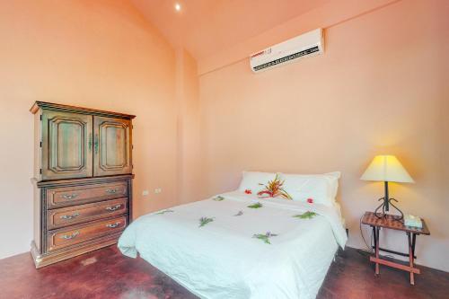 a bedroom with a bed and a dresser and a lamp at Casita at Morningstar Breeze Gold Standard Certified in Hopkins