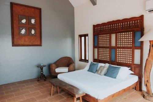 a bedroom with a large bed and a chair at Castle Shore in Catmon