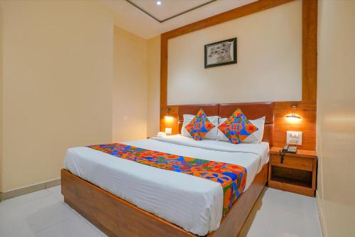 a bedroom with a large bed in a room at FabExpress Colaba Grand in Mumbai