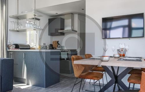 a kitchen and dining room with a table and chairs at Houseboat Waterlelie in Ohé en Laak