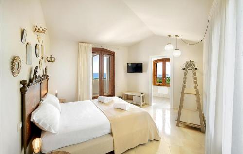 Un dormitorio con una gran cama blanca y una escalera en Cozy Home In Ragusa With Outdoor Swimming Pool, en Ragusa