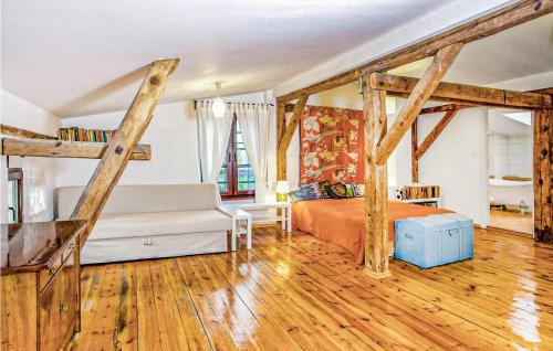 a bedroom with a bed and wooden beams at Cozy Home In Sasino With Kitchen in Sasino