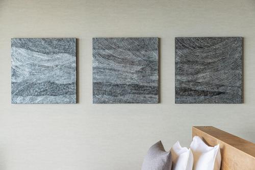 four pieces of art on a wall with shoes at WEAZER 西伊豆 in Izu