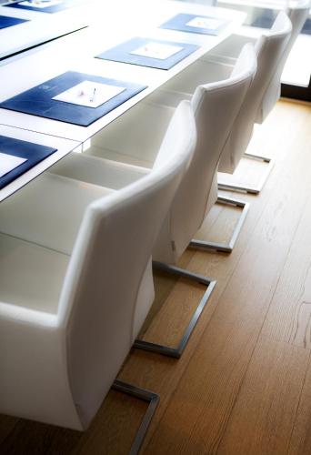 a row of white chairs at a table at Stord Hotel in Stord
